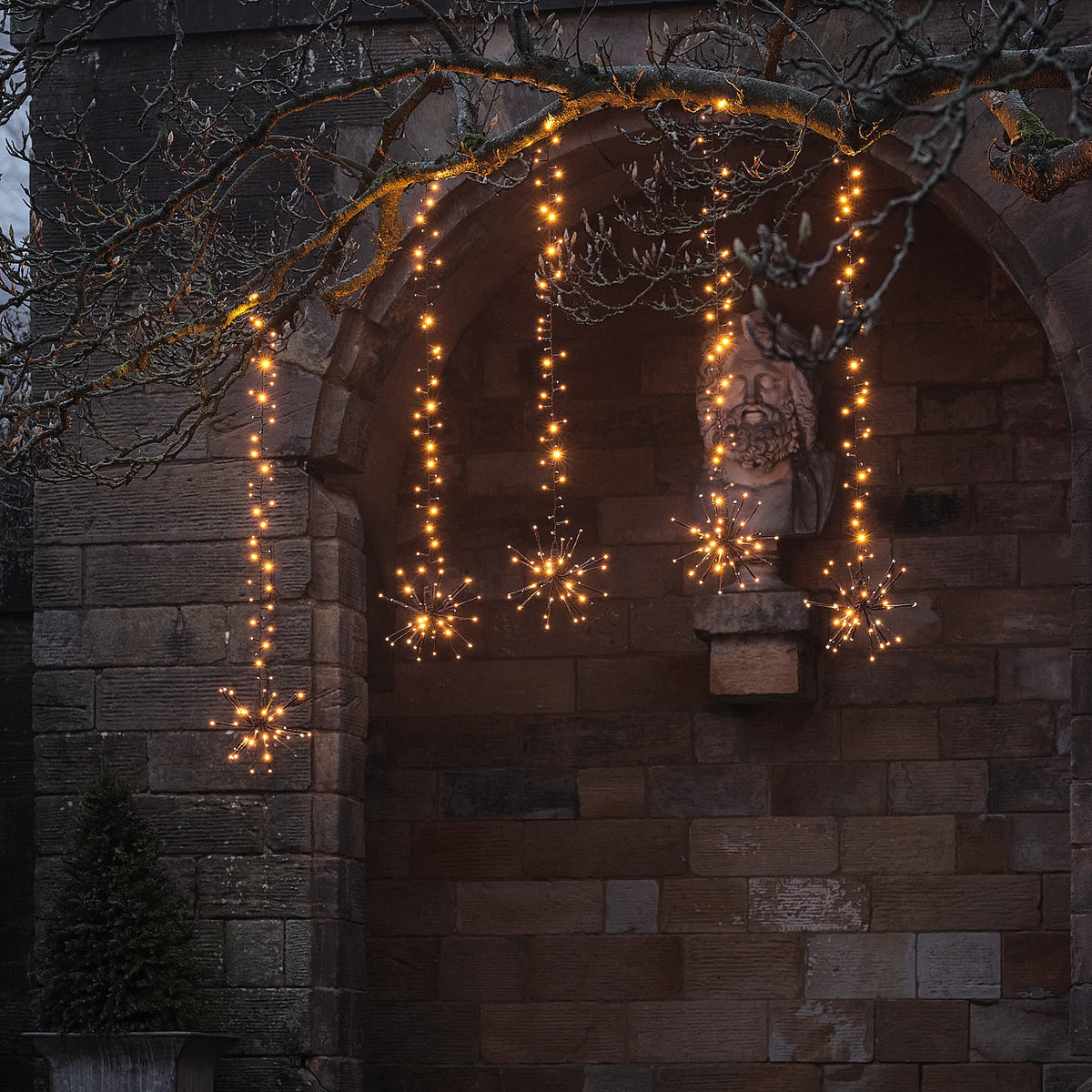 Warmweiße LED-Starburst-Hängedeko für Bäume außen mit Blinkeffekt am Baum